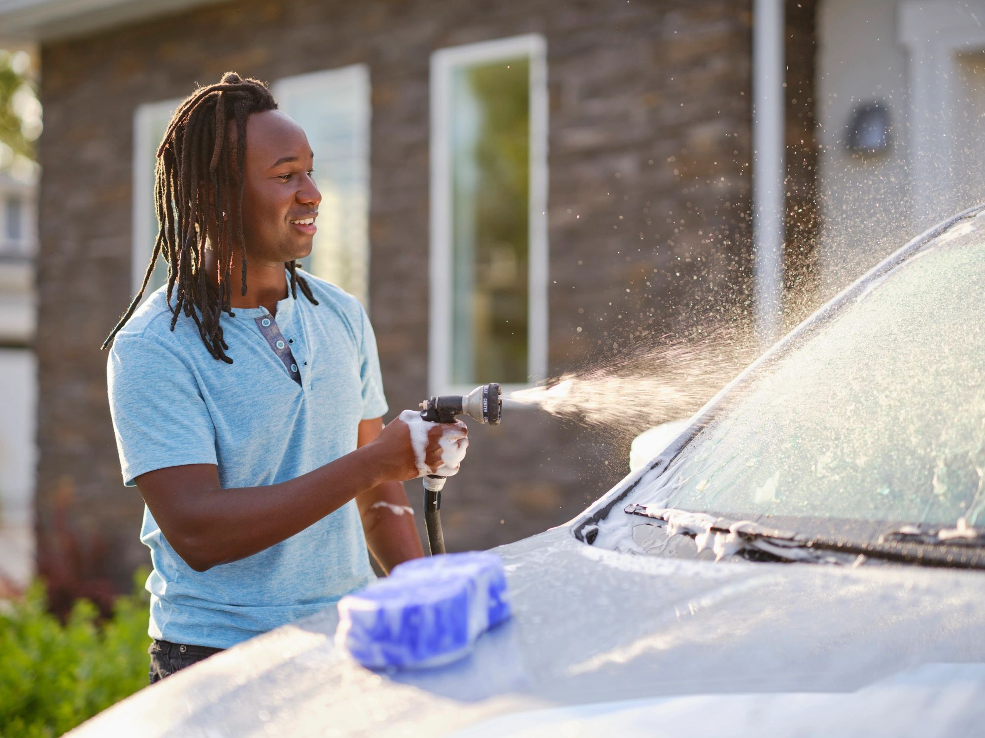 Happy car owner with a clean car after a wash