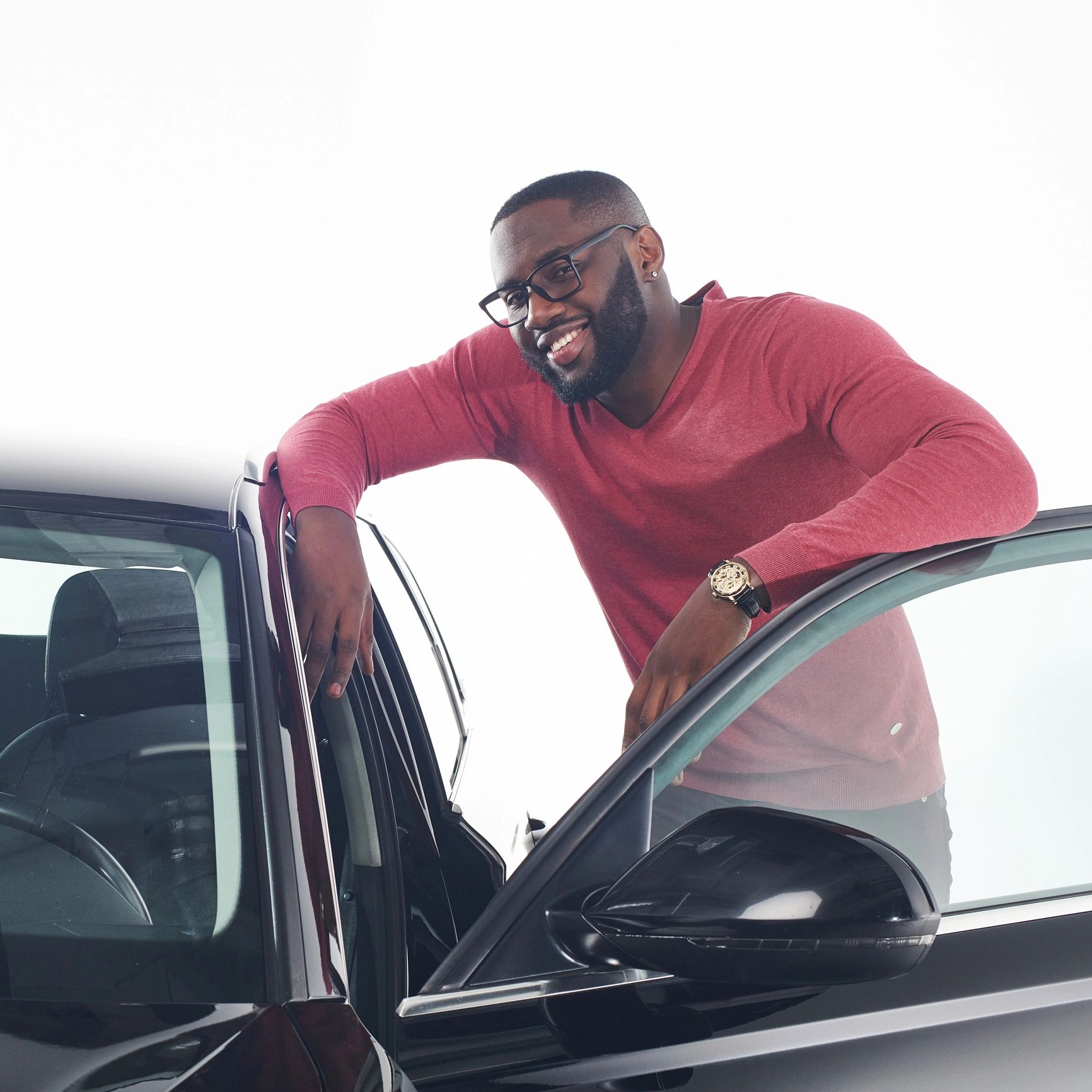 Customer standing proudly next to a clean car